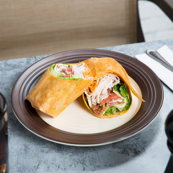 A tortilla wrap with chicken and vegetables on an Elite Global Solutions Durango melamine plate.