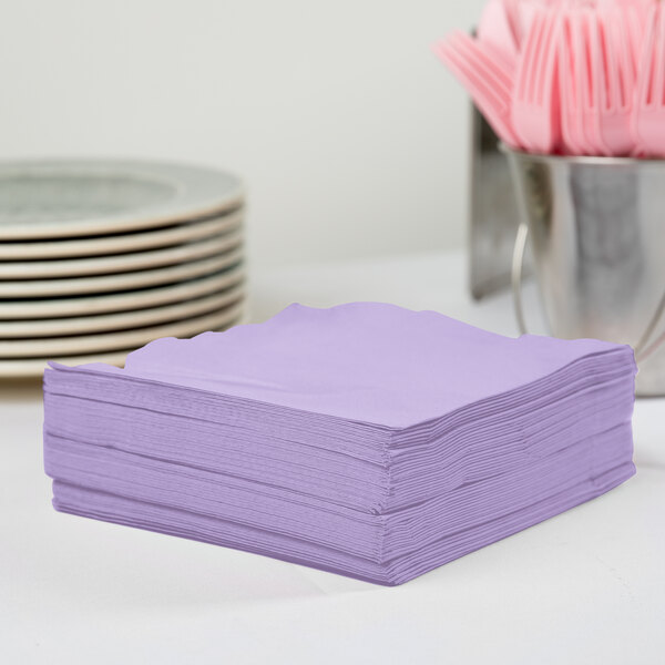 A stack of Creative Converting Luscious Lavender 1/4 Fold Luncheon Napkins.