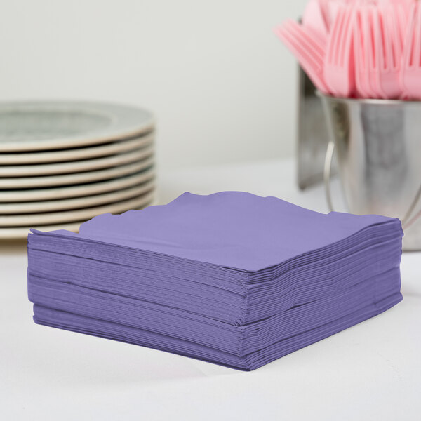 A stack of purple Creative Converting paper napkins.
