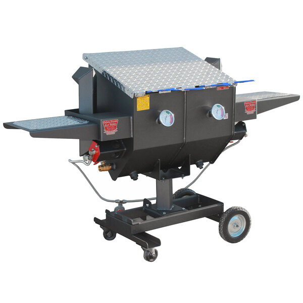 A large black R & V Works outdoor fryer machine with wheels.