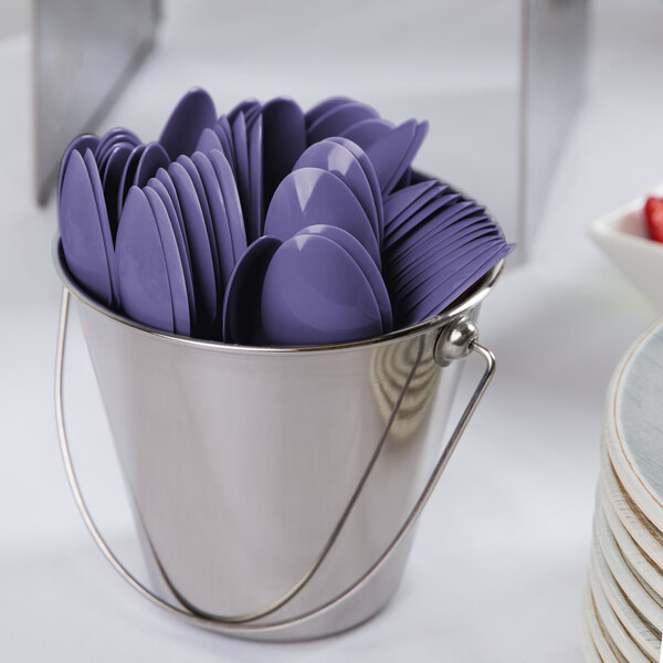 A bucket filled with purple spoons.
