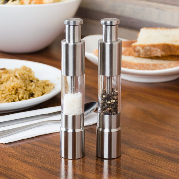 An American Metalcraft stainless steel salt and pepper mill set on a table.