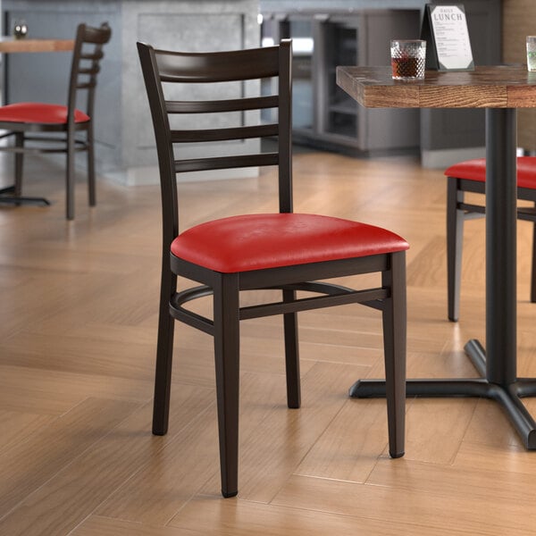 Lancaster Table & Seating Spartan Series Metal Ladder Back Chair with Dark Walnut Wood Grain Finish and Red Vinyl Seat - Assembled