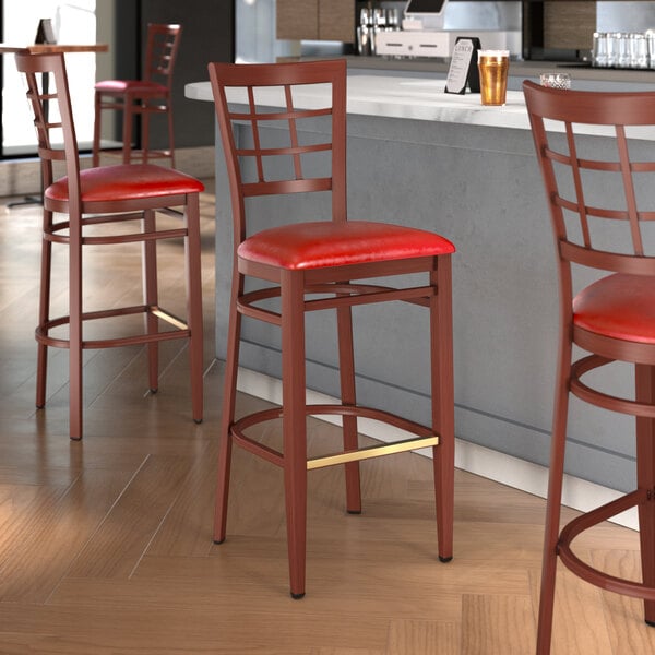 Lancaster Table & Seating Spartan Series Metal Window Back Bar Stool with Mahogany Wood Grain Finish and Red Vinyl Seat - Assembled