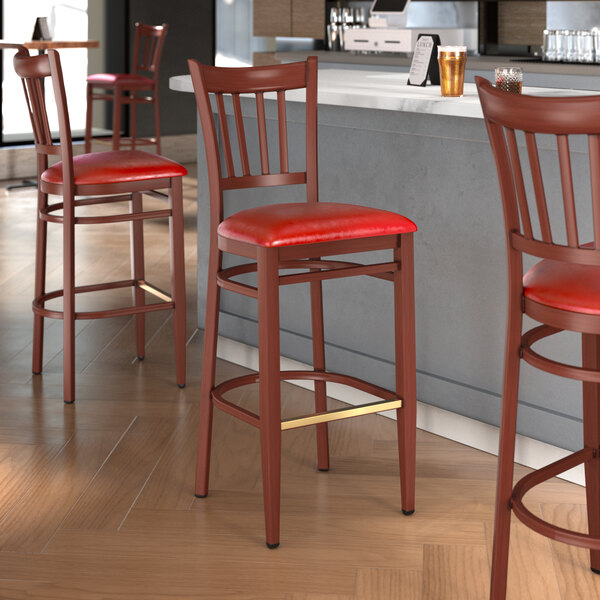 Lancaster Table & Seating Spartan Series Metal Slat Back Bar Stool with Mahogany Wood Grain Finish and Red Vinyl Seat - Assembled