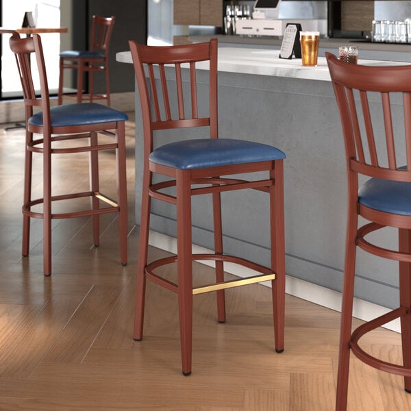 Lancaster Table & Seating Spartan Series Metal Slat Back Bar Stool with Mahogany Wood Grain Finish and Navy Vinyl Seat - Detached Seat