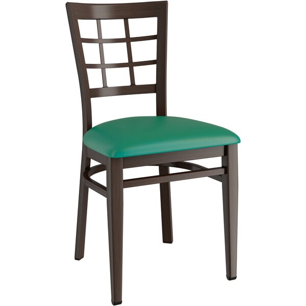 A Lancaster Table & Seating Spartan Series chair with a dark wood frame and green vinyl seat.