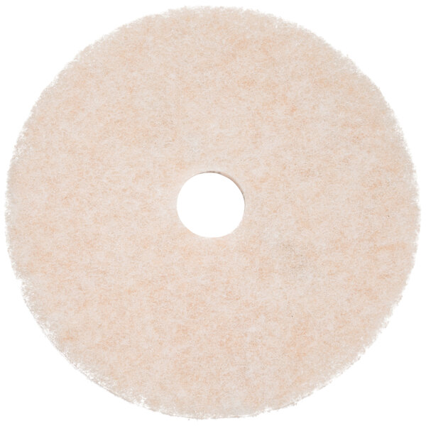 A white circular 3M TopLine Speed floor pad with a hole in the middle.