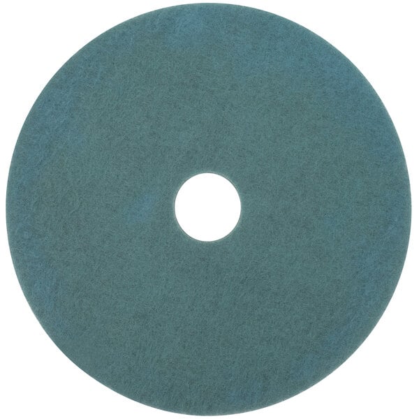 A blue circular 3M Aqua burnishing pad with a hole in the middle.