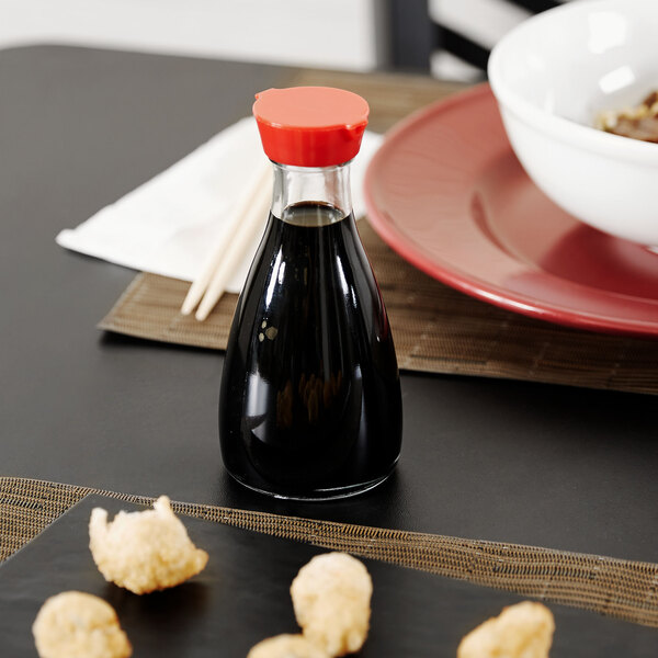 A Town Red Top Soy Sauce bottle on a table with food.