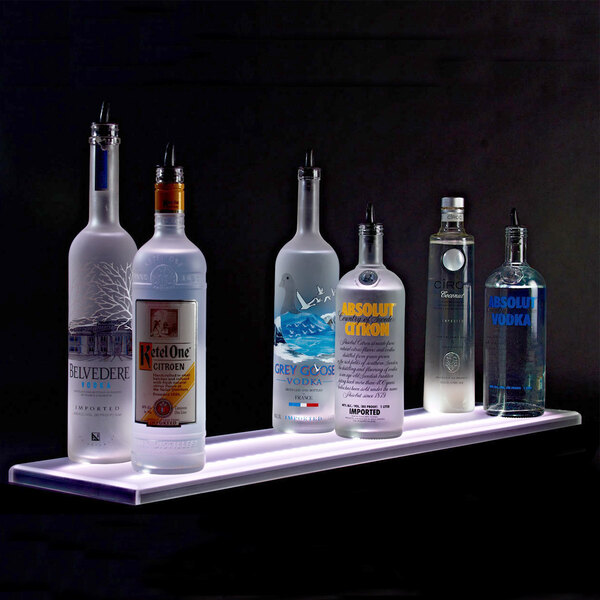 A Beverage-Air liquor shelf with several bottles of alcohol on it.