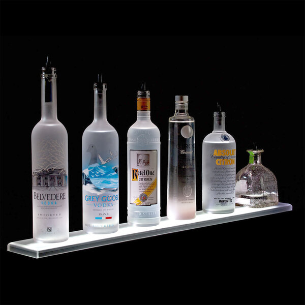 A row of Beverage-Air liquor bottles on a lit shelf.