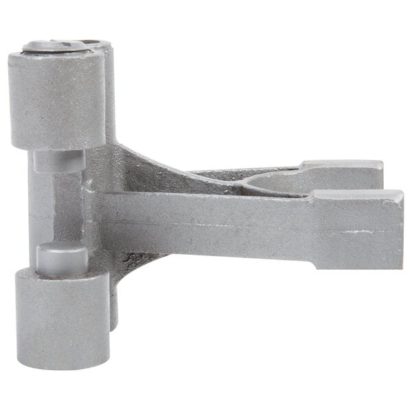 A grey metal Avantco fork bracket with two round objects.