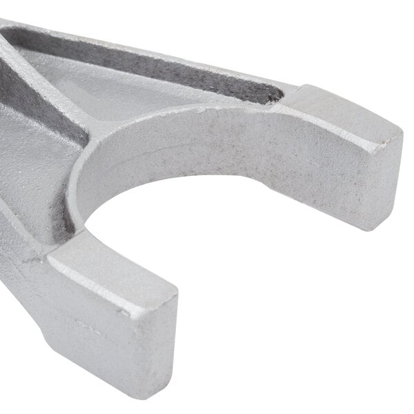 A silver metal Avantco fork with a curved end.