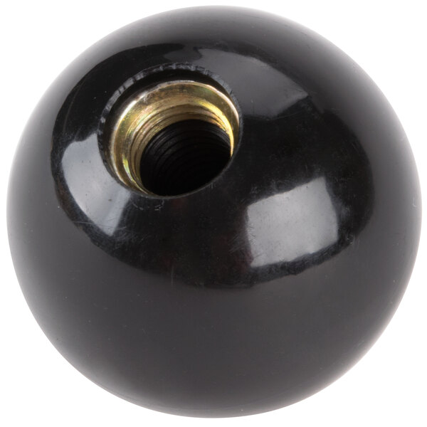 A black ball with a metal nut on it.
