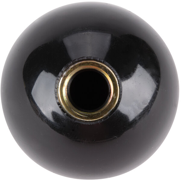A black ball with a gold metal center.