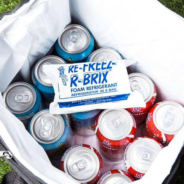 A cooler filled with Polar Tech Re-Freez-R-Brix foam freeze packs and cans of soda.