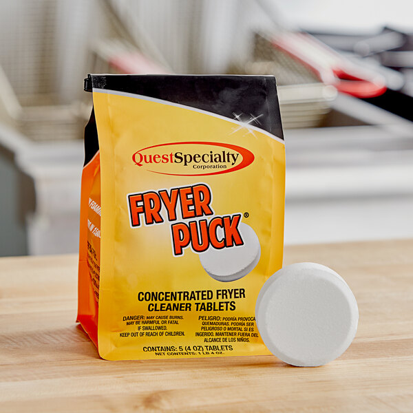 A bag of Fryer Puck cleaner tablets on a table.