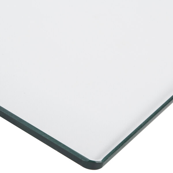 A close-up of a white glass door with a green border.