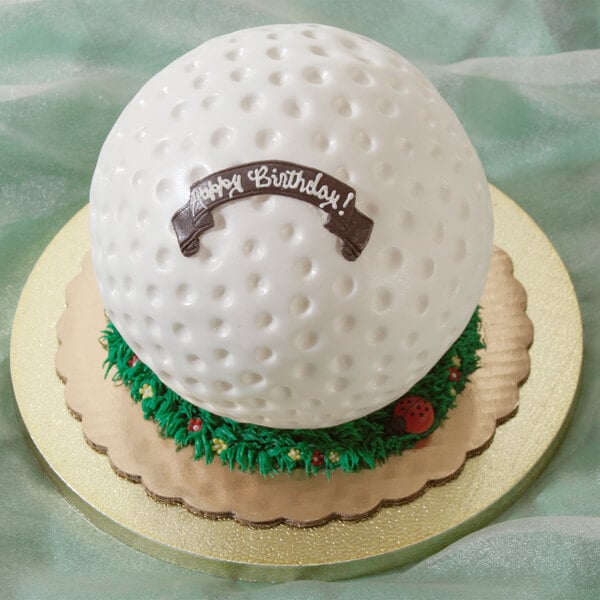 A white cake shaped like a golf ball made using an Ateco stainless steel hemisphere food mold.