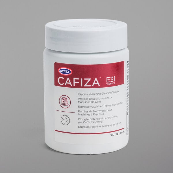 A white bottle of Urnex Cafiza Espresso Machine Cleaning Tablets with a red label.