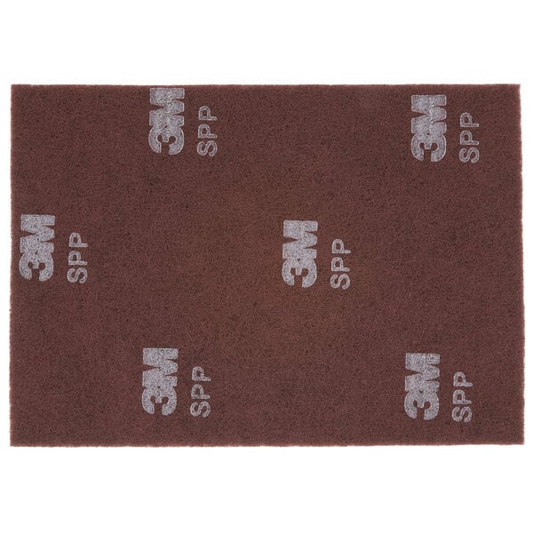 A brown 3M Scotch-Brite surface preparation pad with white text that says "SPP"