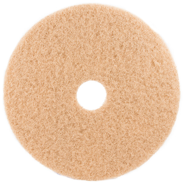 A white circular 3M tan burnishing floor pad.