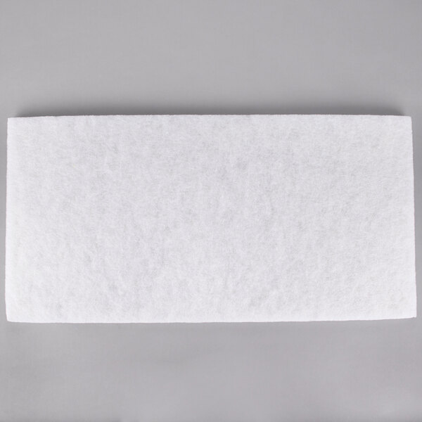 A white rectangular 3M Super Polishing Pad on a gray surface.