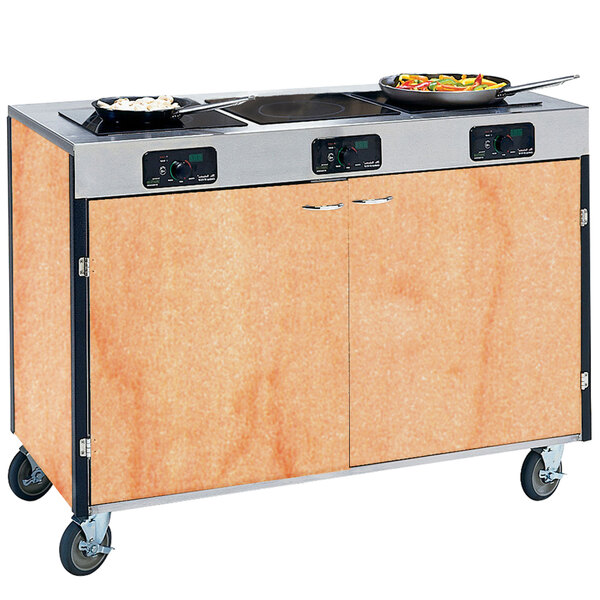 A Lakeside mobile cooking cart with induction burners and pans on top.
