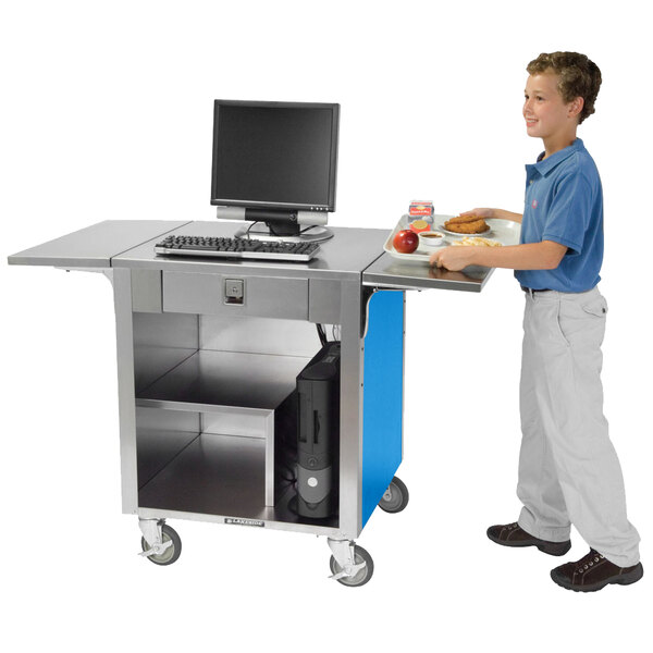 A boy standing at a Lakeside cash register stand with a laptop.