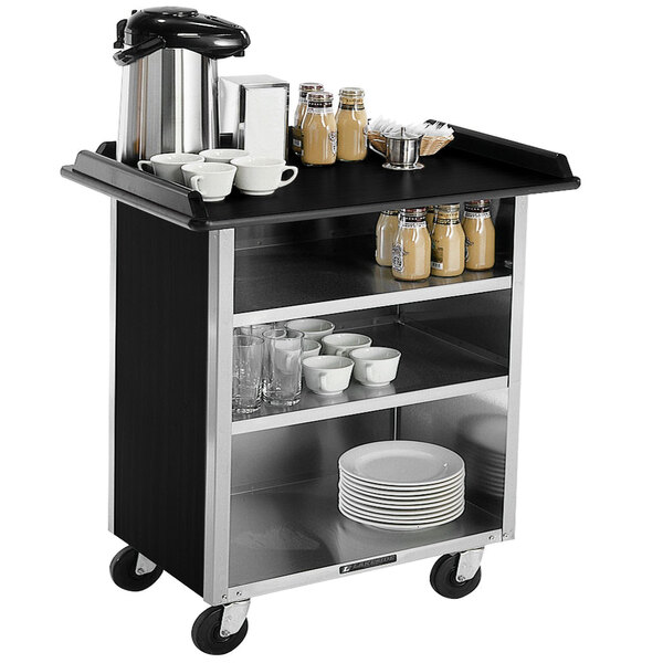 A Lakeside stainless steel beverage service cart with black laminate shelves holding dishes and cups.