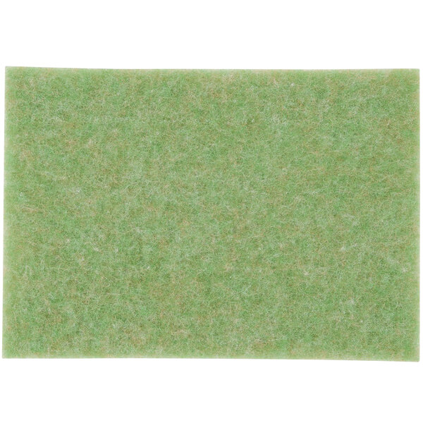 A green felt pad on a white background.