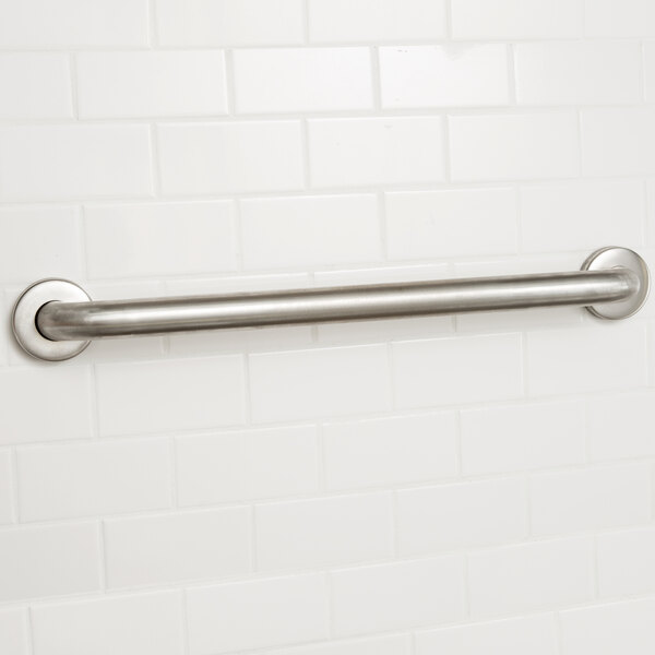 A stainless steel Lavex grab bar on a white tile wall.