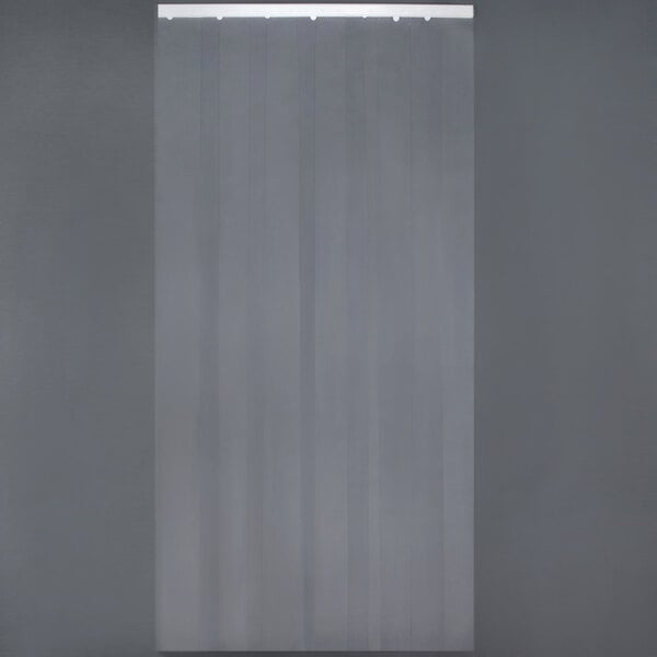 A gray Curtron PVC strip door with white strips hanging on a wall.