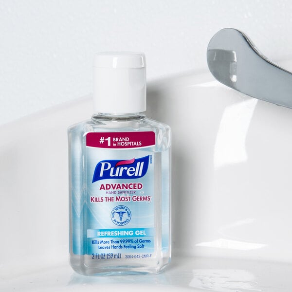 A case of 24 Purell Advanced hand sanitizer bottles on a counter.