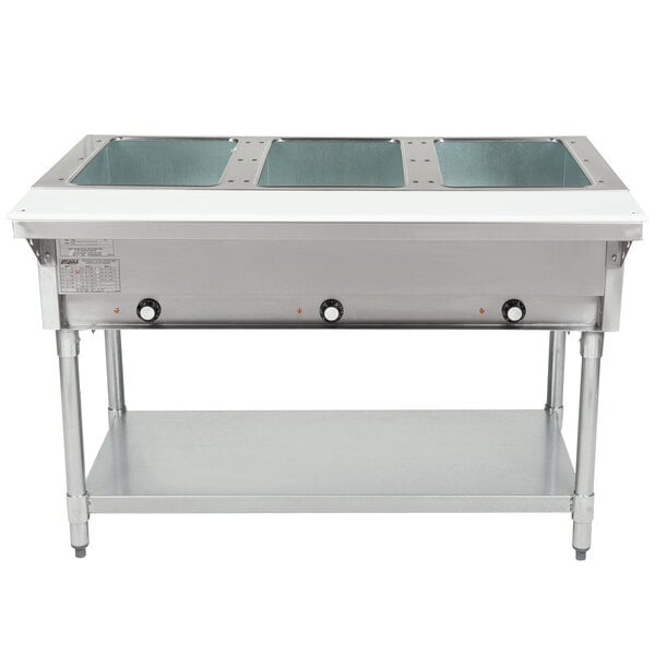 An Eagle Group stainless steel open well electric hot food table with three pans inside.