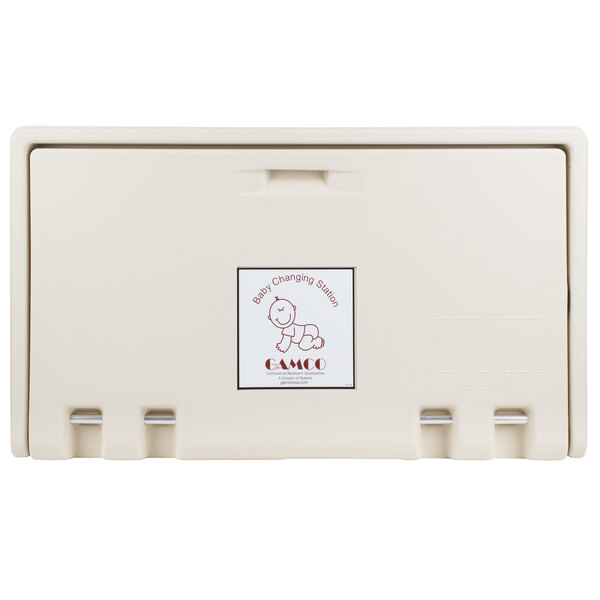 A cream plastic box with the words "Baby Changing Station" in white.