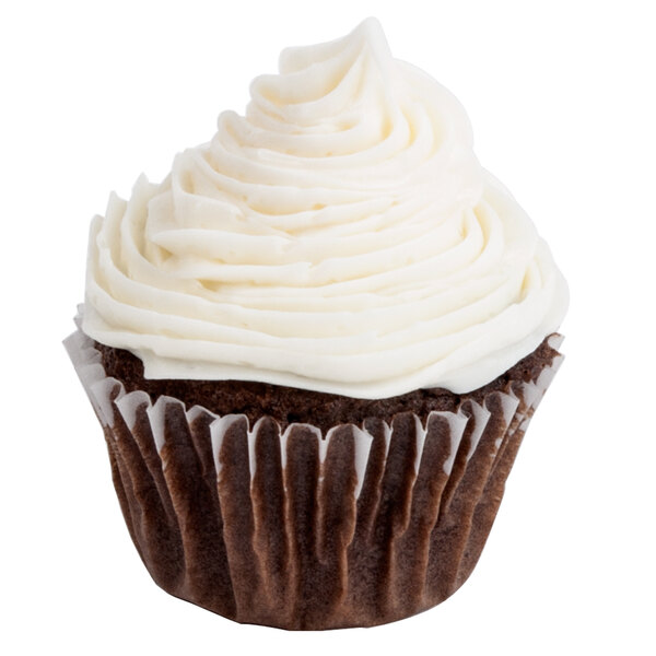 A close-up of a cupcake in a white Hoffmaster fluted baking cup with white frosting.