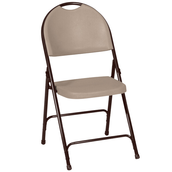 A tan plastic folding chair with a brown metal frame.