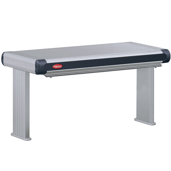 A grey rectangular Hatco strip warmer with black controls on a stainless steel table.