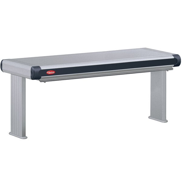 A grey rectangular Hatco Decorative Strip Warmer on a stainless steel table with black and red accents.