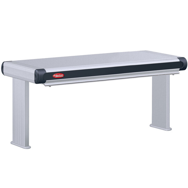 A white table with a Hatco Glo-Ray double infrared strip warmer with black and red accents.