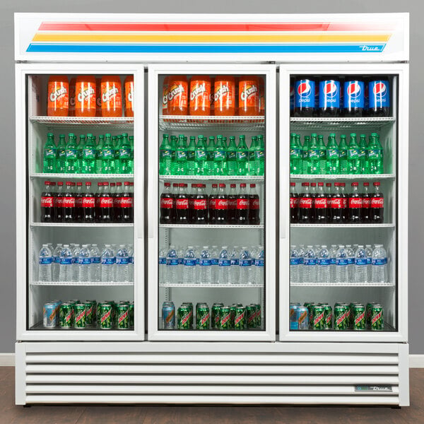 A white True refrigerated merchandiser with bottles of soda and water.