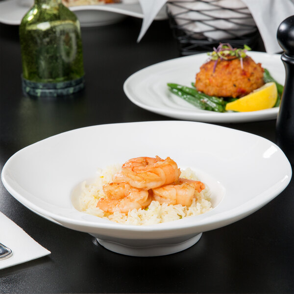 A 10 Strawberry Street bright white porcelain bowl filled with shrimp and rice.