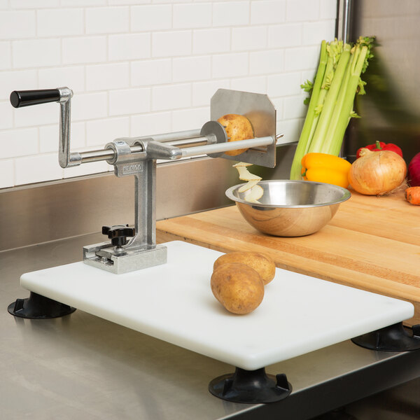 A Nemco portable base for an Easy Slicer with a potato on it.