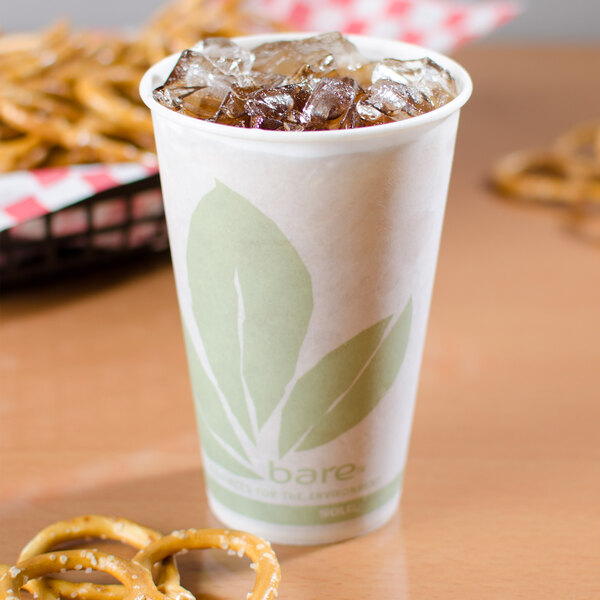A Bare by Solo paper cold cup with ice and a leaf design filled with ice tea.