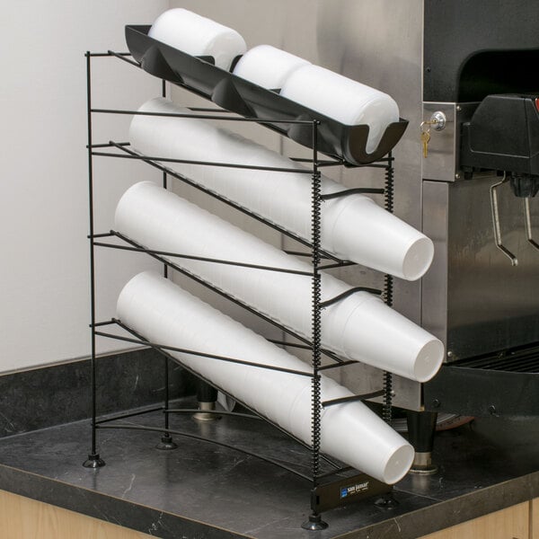 A San Jamar Wireworks countertop organizer with white plastic cups in it.