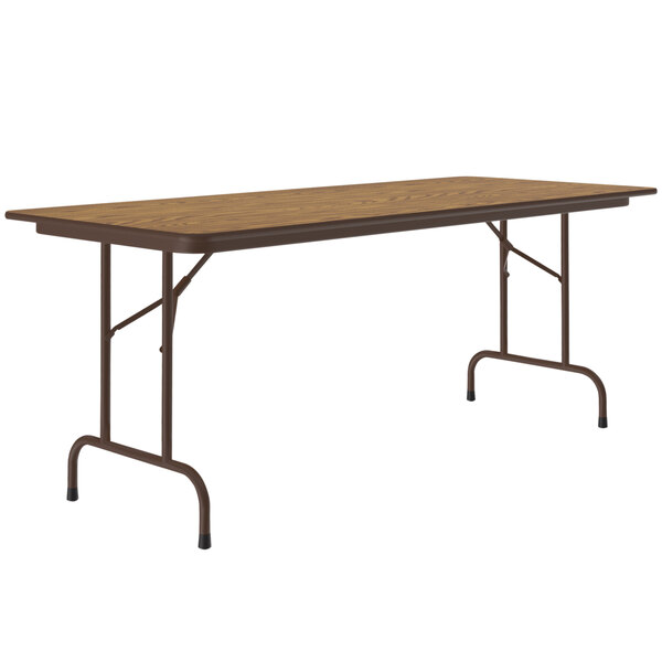 A medium oak rectangular table with metal legs.