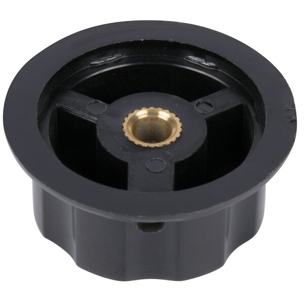 A black plastic circular knob with a gold center.