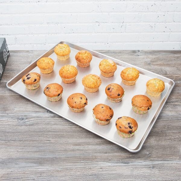 A Chicago Metallic bakery display tray holding muffins on a table.